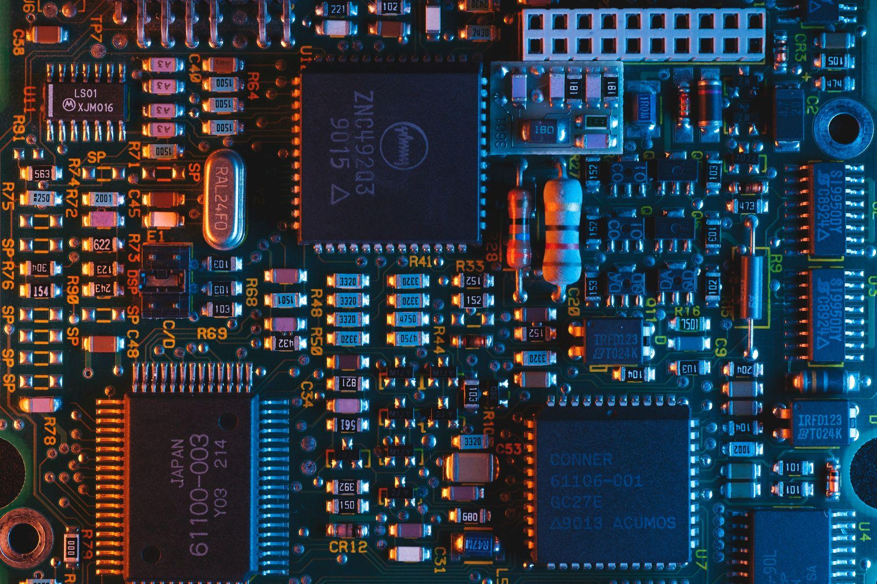 Close-up of an illuminated circuit board with interconnected electronic components