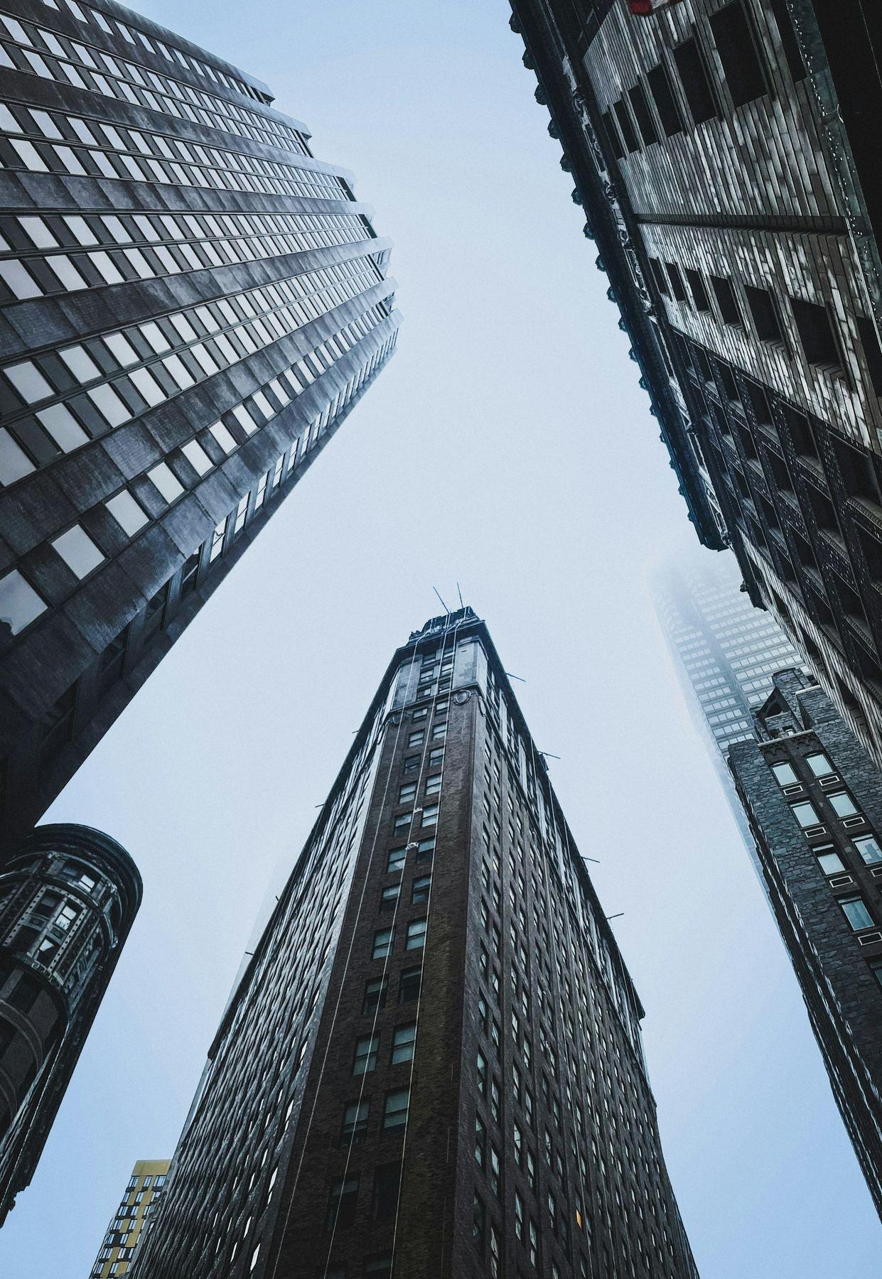 View looking upward between tall buildings in a financial district